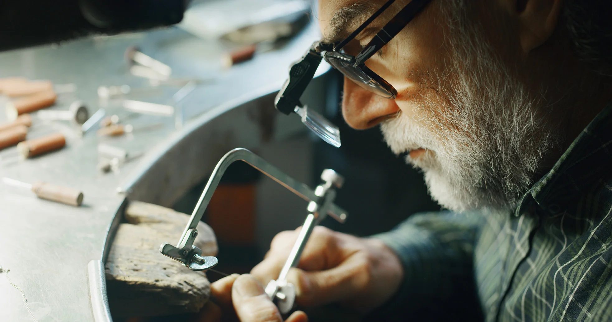 Watch repair specialist examining a timepiece and preparing precision tools