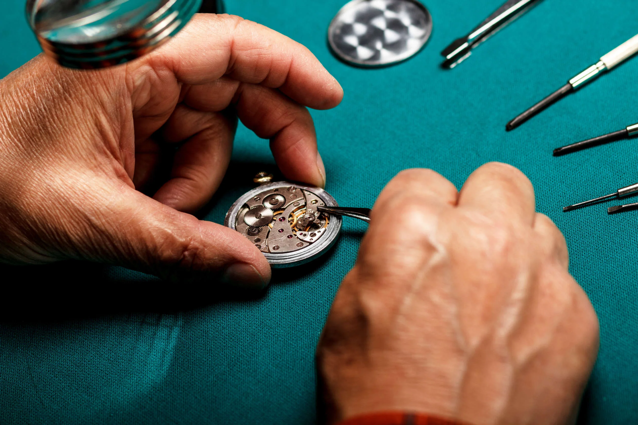 Precision watchmaking tools and repair instruments arranged for detailed timepiece servicing