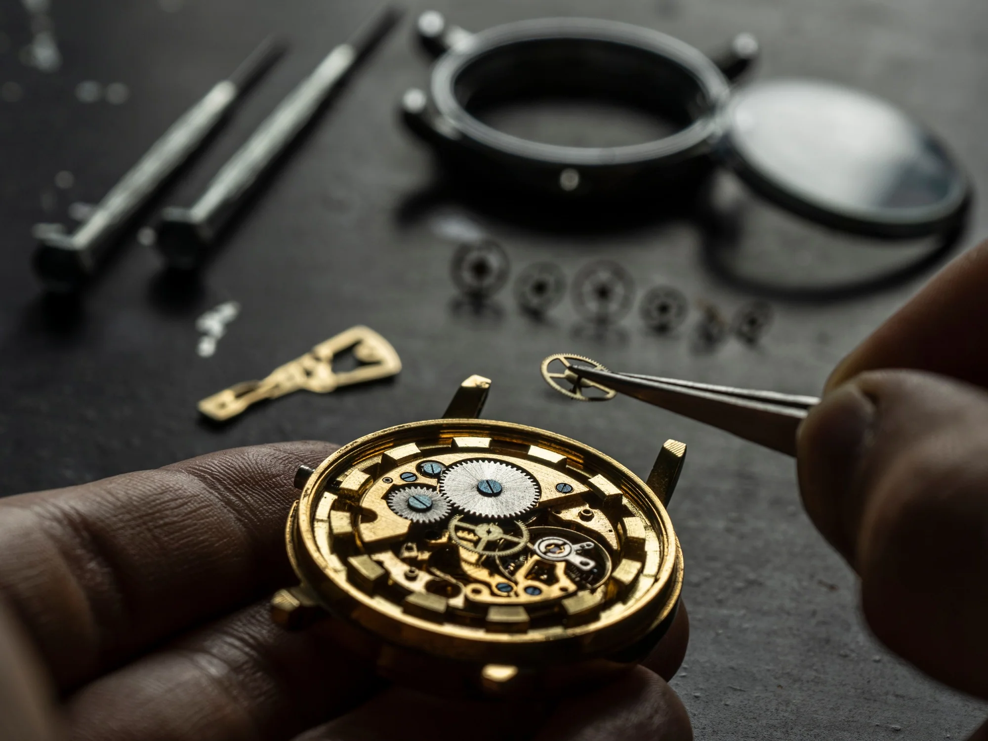 Watchmaker's workbench with precision tools and a timepiece ready for inspection